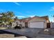 Welcoming single-story home with a neat front yard, beautiful tile roof, and a convenient two-car garage at 7038 N 28Th Ave, Phoenix, AZ 85051