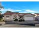 Charming single-story home featuring a well-manicured front yard, tile roof, and an attached two-car garage at 7038 N 28Th Ave, Phoenix, AZ 85051