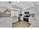 Updated kitchen featuring white cabinets, stainless steel appliances, and modern finishes throughout at 7038 N 28Th Ave, Phoenix, AZ 85051