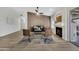 Spacious living room featuring modern decor, a fireplace, a contemporary ceiling fan, and lots of natural light at 7038 N 28Th Ave, Phoenix, AZ 85051