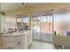 Bathroom with dual sink vanity, sliding glass doors out to the pool area at 7102 E Larkspur Dr, Scottsdale, AZ 85254