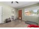 Sunlit bedroom with exterior door and view to a pergola at 7102 E Larkspur Dr, Scottsdale, AZ 85254