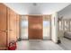 The home entryway has light beige walls, and wood paneling, featuring a unique front door at 7102 E Larkspur Dr, Scottsdale, AZ 85254