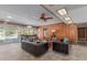 The living room has wooden paneling, and glass doors leading to the outdoor pool area at 7102 E Larkspur Dr, Scottsdale, AZ 85254