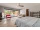 Sunny main bedroom with door to patio, ceiling fan, and view to swimming pool at 7102 E Larkspur Dr, Scottsdale, AZ 85254