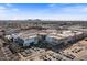 Aerial view of a shopping center surrounded by flourishing vegetation, trees, and expansive parking at 7157 E Rancho Vista Dr # 2012, Scottsdale, AZ 85251