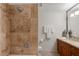 Elegant bathroom featuring tiled shower and vanity with wood cabinets at 7157 E Rancho Vista Dr # 2012, Scottsdale, AZ 85251