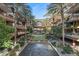 Beautiful courtyard with mature palm trees, a putting green, fountain, and lounge seating at 7157 E Rancho Vista Dr # 2012, Scottsdale, AZ 85251