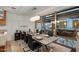 Elegant dining room with a modern chandelier, a sleek table, and large windows offering ample natural light at 7157 E Rancho Vista Dr # 2012, Scottsdale, AZ 85251