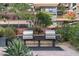 Outdoor grilling area with built-in grills, countertop space, and lush landscaping at 7157 E Rancho Vista Dr # 2012, Scottsdale, AZ 85251