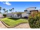 Lush backyard showcasing green grass, blooming flowers, and a shed at 7644 E Mariposa Dr, Scottsdale, AZ 85251