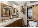 Bathroom features a double sink vanity, framed mirror, and a decorative shelf at 7644 E Mariposa Dr, Scottsdale, AZ 85251