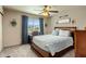 Cozy bedroom featuring a ceiling fan, a large window, and comfortable furnishings at 7644 E Mariposa Dr, Scottsdale, AZ 85251