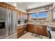 Well-lit kitchen features wooden cabinets, stainless steel appliances, and granite countertops at 7644 E Mariposa Dr, Scottsdale, AZ 85251