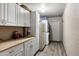 Bright laundry room with white cabinetry, washer, and dryer at 7644 E Mariposa Dr, Scottsdale, AZ 85251