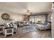 Sun-filled living room with hardwood floors, stylish furniture, and sliding glass doors to the patio at 7644 E Mariposa Dr, Scottsdale, AZ 85251