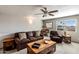 Cozy living room with a ceiling fan and comfortable leather furniture at 7644 E Mariposa Dr, Scottsdale, AZ 85251