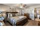 Spacious bedroom features a dark wood bed frame, carpet, and barn door to the bathroom at 7644 E Mariposa Dr, Scottsdale, AZ 85251