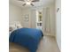 Comfortable bedroom with a blue comforter, soft carpet, and a bright window with sheer curtains at 7726 E Baseline Rd # 110, Mesa, AZ 85209