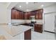 Kitchen boasts granite countertops, stainless steel appliances, and dark wood cabinets at 7726 E Baseline Rd # 110, Mesa, AZ 85209