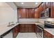 Well-equipped kitchen featuring granite countertops, stainless steel appliances, and ample cabinet space at 7726 E Baseline Rd # 110, Mesa, AZ 85209