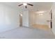 Bright living room showing carpet, entry to dining area, and an archway to another room at 7726 E Baseline Rd # 110, Mesa, AZ 85209