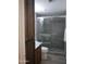 Updated bathroom features a large tile shower with a glass door, wooden vanity, and marble countertop at 7950 E Starlight Way # 128, Scottsdale, AZ 85250