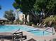 Large community pool area with lounge chairs, a spa, and lush landscaping at 7950 E Starlight Way # 128, Scottsdale, AZ 85250