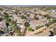 Expansive aerial view of a residential neighborhood featuring well-maintained homes, green spaces, and community amenities at 8421 W Alex Ave, Peoria, AZ 85382