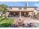 Outdoor living space featuring covered patio, dining area, pool view, and well-manicured lawn at 8421 W Alex Ave, Peoria, AZ 85382