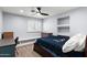 Comfortable bedroom featuring window with shutters, ceiling fan, and built in shelves at 8421 W Alex Ave, Peoria, AZ 85382