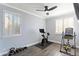 Bright exercise room with plantation shutters, wood-look floors, and a ceiling fan at 8421 W Alex Ave, Peoria, AZ 85382