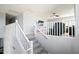 Upstairs view of the carpeted staircase leading to the open-concept floorplan at 8421 W Alex Ave, Peoria, AZ 85382