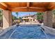 Relaxing hot tub experience with a view of the lush backyard and home at 8421 W Alex Ave, Peoria, AZ 85382