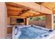 Inviting hot tub under a wooden pergola, complete with a mounted TV at 8421 W Alex Ave, Peoria, AZ 85382