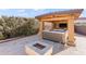 Outdoor hot tub with stone fire pit in a private, covered patio setting at 8421 W Alex Ave, Peoria, AZ 85382