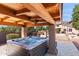 Outdoor hot tub under a wooden pergola overlooking the pool and backyard at 8421 W Alex Ave, Peoria, AZ 85382