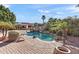 Resort-style pool with rock waterfall, slide, and mature landscaping, perfect for outdoor entertaining at 8421 W Alex Ave, Peoria, AZ 85382