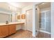 Bathroom featuring a vanity, closet and a glass-enclosed shower at 8772 W Grovers W Ave, Peoria, AZ 85382