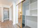 Hallway featuring closet with mirrored doors and a view into the bathroom with shower at 8772 W Grovers W Ave, Peoria, AZ 85382