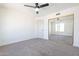 Bright bedroom featuring ceiling fan, closet and neutral carpet at 8772 W Grovers W Ave, Peoria, AZ 85382