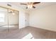 Bright bedroom with ceiling fan, mirror closet and neutral carpet at 8772 W Grovers W Ave, Peoria, AZ 85382