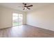 Bedroom featuring wood floors, sliding glass door access to a small yard at 8772 W Grovers W Ave, Peoria, AZ 85382