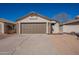 A home featuring a two-car garage with stone accents and xeriscaping for low maintenance at 8772 W Grovers W Ave, Peoria, AZ 85382