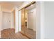 View of the hallway with closet with mirrored doors, leading to a bathroom at 8772 W Grovers W Ave, Peoria, AZ 85382