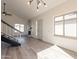 Living room boasts vaulted ceiling, stone fireplace, neutral paint, and sleek stair railing at 8772 W Grovers W Ave, Peoria, AZ 85382