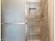 Close-up of the tiled shower with glass door and a niche at 8772 W Grovers W Ave, Peoria, AZ 85382