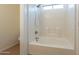 Clean white bathtub with tiled surround and showerhead, offering a relaxing bathing experience at 9705 E Butte St, Mesa, AZ 85207