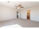 Large bedroom with plush carpeting, ceiling fan, and ensuite bathroom at 9705 E Butte St, Mesa, AZ 85207