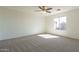 Bright and airy bedroom with plush carpeting and a large window offering natural light at 9705 E Butte St, Mesa, AZ 85207